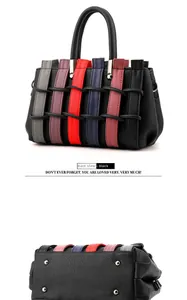 Detail view showing black textured leather weave and bottom rivets on handbag