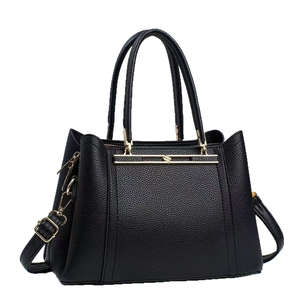 Elegant black pebbled leather tote bag with gold metal accents and shoulder strap