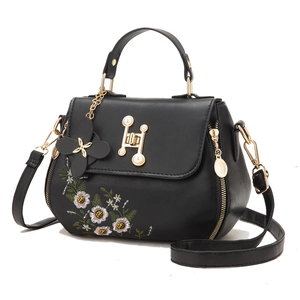 Elegant black bucket bag with floral embroidery and pearl H buckle on white background