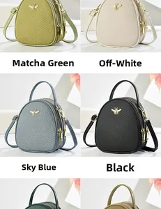 Detailed view of mini crossbody bags in four colors with gold bee logo and triple zippers