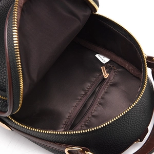 Interior view of black litchi pattern leather backpack with gold zipper pocket