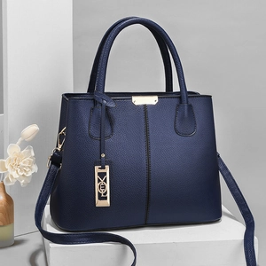 Deep blue lychee textured leather tote with gold hardware and detachable shoulder strap