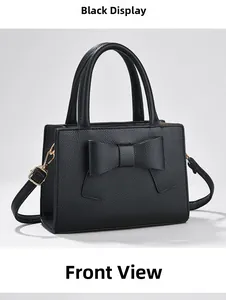 Vue avant du sac à main noir avec nœud en cuir grainé et finitions métalliques dorées