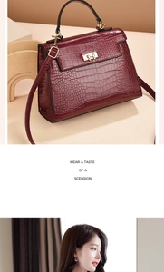 Close-up of wine red crocodile embossed texture and golden metal lock on handbag