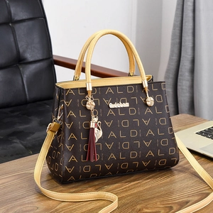 Sac à main marron avec logo et poignées jaunes sur un bureau professionnel