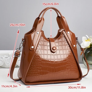 Detail showing dimensions of brown crocodile pattern handbag with dimensions and metal hardware