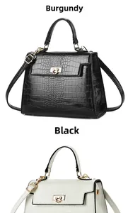 Detail view of crocodile pattern texture on black and cream white trapezoid handbags