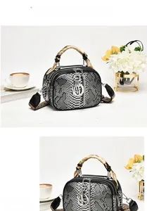 Detailed view of python skin handbag with silk scarf handle and silver metal hardware