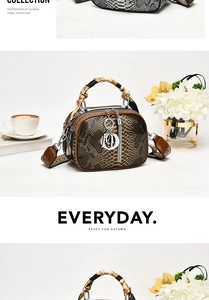 Macro shot of faux snakeskin leather lady bag with silk scarf handle and D-letter charm