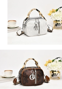 Detail of snake skin texture handbags with silk scarves on handles and metal charms