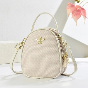 Beige egg-shaped handbag with gold bee ornament and multi-zipper compartments