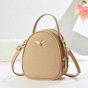 Elegant woven crossbody handbag in beige featuring a golden bee logo and dual zippers