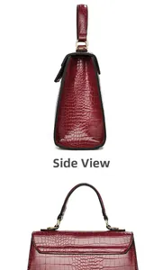 Detail view of burgundy crocodile-embossed leather texture and gold metal ring hardware