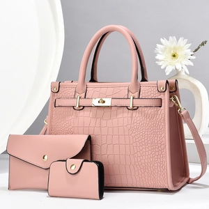 Detailed set of pink crocodile texture handbags with elegant hardware on a clean background