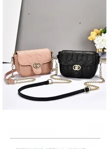 Close-up of quilted chain shoulder bag with gold ring lock in pink and black colors