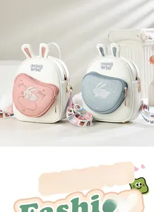 Detail of pink and blue bunny backpacks featuring cute rabbit ears and embroidered accents