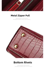 Detail showing burgundy crocodile pattern leather with gold zipper and bottom rivets