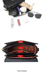 Détail de la structure interne multicouche spacieuse du sac à bandoulière noir matelassé