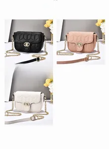 Detail of quilted chain bags in black, pink, and white with golden metal locks