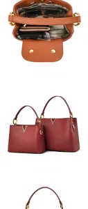 Vue intérieure du sac à main bordeaux en cuir grainé avec boucle en V dorée et grand espace