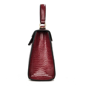 Classic dark red crocodile pattern handbag with elegant top handle and golden hardware