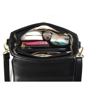 Striped crossbody bag with turn-lock closure showing spacious internal storage compartments