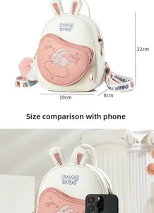 Detailed size view of a cute bunny backpack 19x8x22cm compared to a smartphone