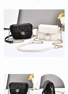 Detail view of black and beige quilted chain flap bags with golden hardware accents