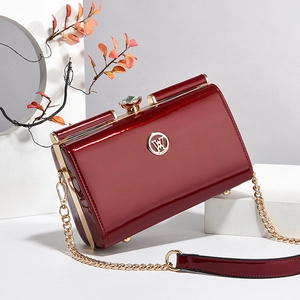 Elegant deep red patent leather handbag with gold W logo and chain strap for women