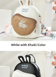 Detail of cute rabbit ear backpacks in white-khaki and black with embroidery