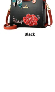 Detail of elegant black tote bag featuring red peony embroidery and chic polka dot scarf