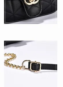 Detail of classic black quilted leather texture and polished golden hardware clasp