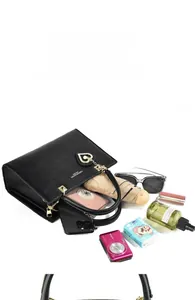 Top view of spacious black leather tote bag with daily items showing large capacity