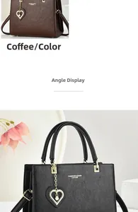 Detail view of lychee leather tote bags with heart pearl charms and golden metal hardware