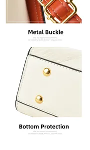 Detail of beige leather handbag featuring golden metal buckle and bottom studs