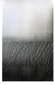 Close-up of black litchi grain leather texture showing soft and durable material