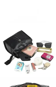Detailed internal view showing large capacity and multiple items inside the black pillow bag