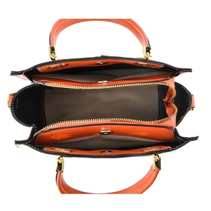Elegant orange embroidered handbag with three compartments and gold hardware details