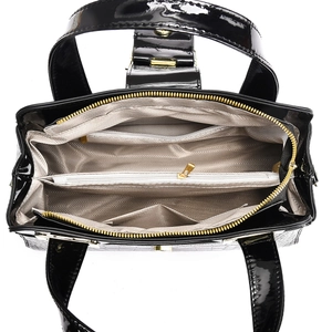 Internal structure of black patent leather shoulder bag with multiple compartments
