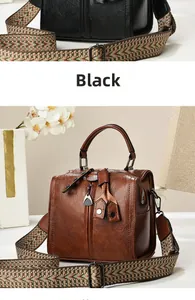 Detail of vintage Boston bag featuring retro leather texture and wide patterned shoulder strap