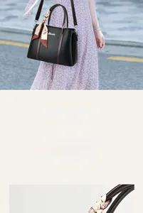 Dettaglio borsa a secchiello in pelle nera con foulard di seta e logo in metallo