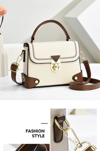 Close-up of golden vintage turn-lock and contrast stitching on a beige shoulder bag
