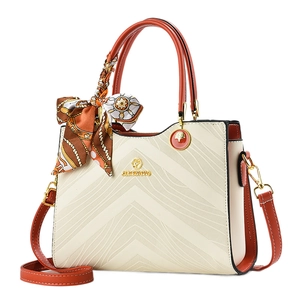 Chic cream and orange embossed leather handbag with silk scarf and gold hardware