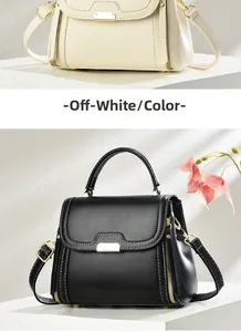 Detail view of retro small square handbags in off-white and black with gold hardware