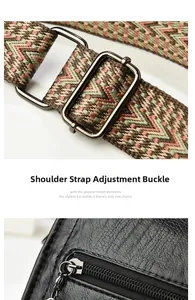 Detail of vintage black leather boston bag with ethnic woven strap and metal buckle