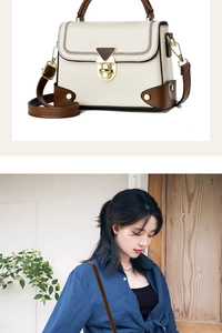 Close-up of contrast stitch V-pattern and gold lock on beige retro shoulder bag