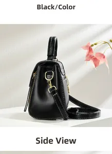 Side view of black crossbody bag with white contrast stitching and gold D-ring detail