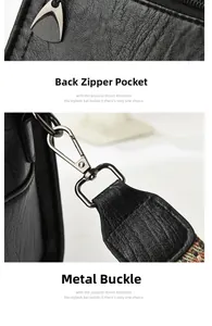 Detail view of black lychee grain leather pillow bag showing rear zipper and metal swivel hook