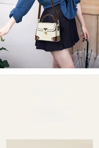 Detailed view of the vintage beige crossbody bag with brown trim and gold swivel lock