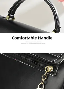 Detail of comfortable black leather handle and gold zipper closure on crossbody bag